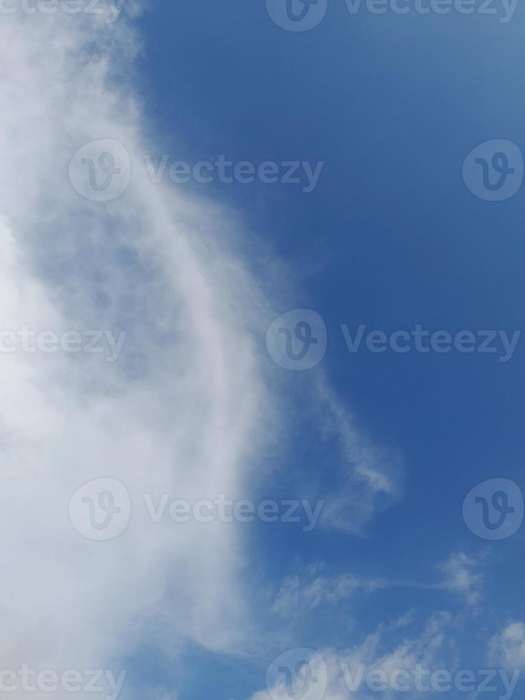 Beautiful white clouds on deep blue sky background. Large bright soft fluffy clouds are cover the entire blue sky. photo