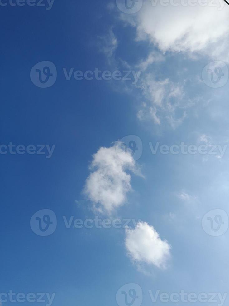 Beautiful white clouds on deep blue sky background. Large bright soft fluffy clouds are cover the entire blue sky. photo