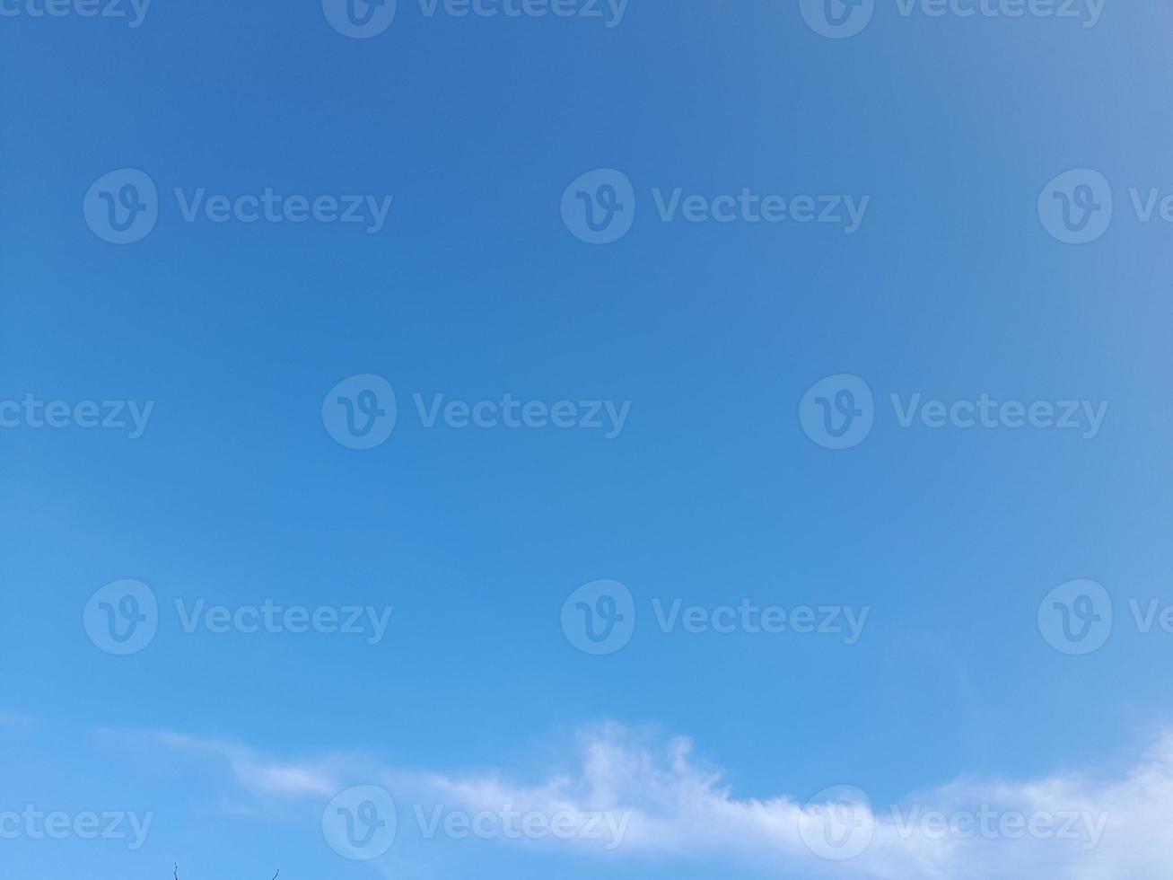 Beautiful white clouds on deep blue sky background. Large bright soft fluffy clouds are cover the entire blue sky. photo