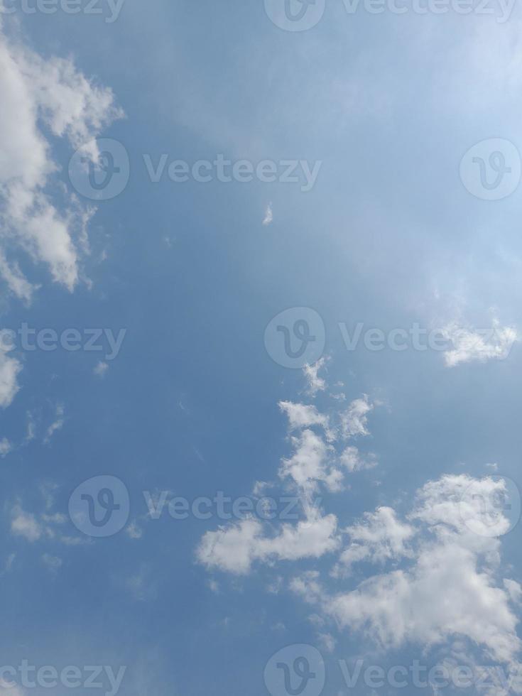 Beautiful white clouds on deep blue sky background. Large bright soft fluffy clouds are cover the entire blue sky. photo