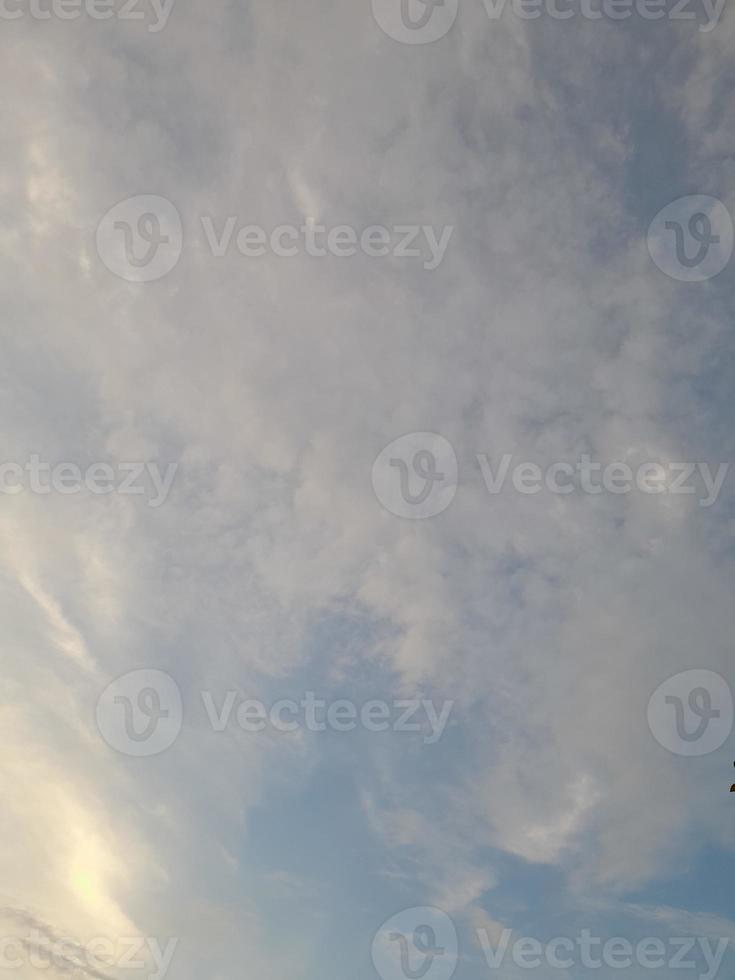 Beautiful white clouds on deep blue sky background. Large bright soft fluffy clouds are cover the entire blue sky. photo