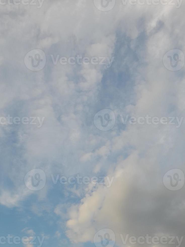 Beautiful white clouds on deep blue sky background. Large bright soft fluffy clouds are cover the entire blue sky. photo