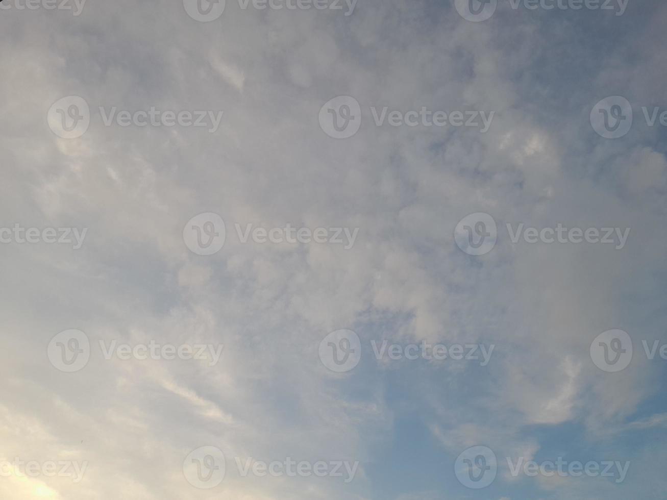 Beautiful white clouds on deep blue sky background. Large bright soft fluffy clouds are cover the entire blue sky. photo