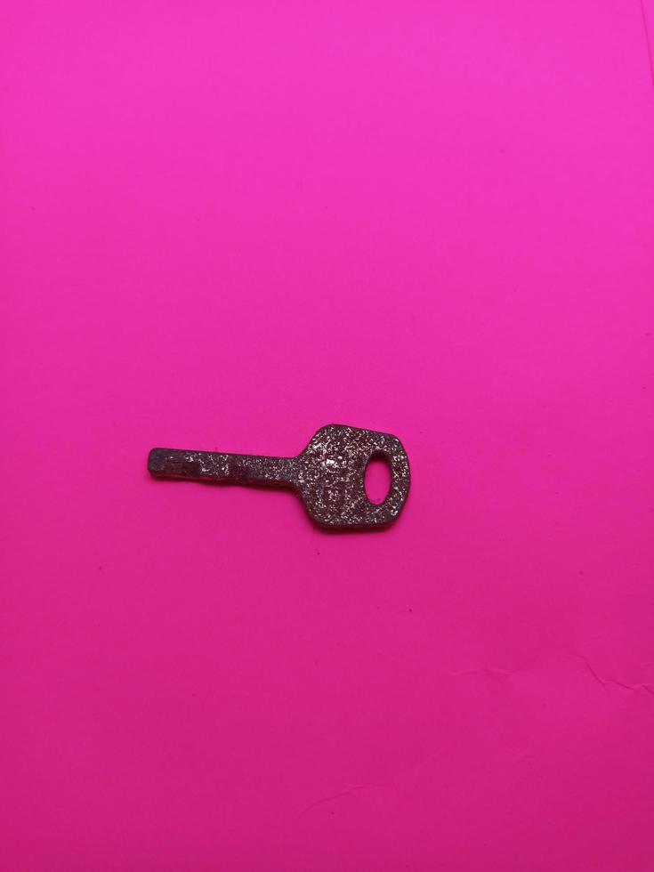 abandoned keys isolated picture with pink background photo