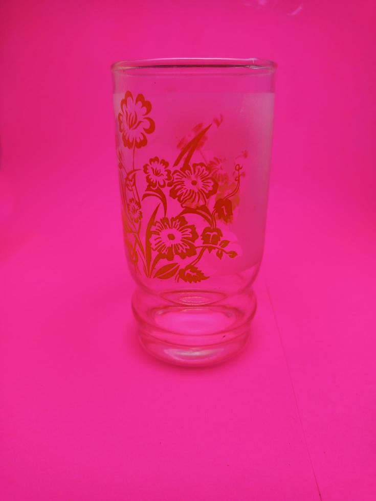 isolated empty glass wirh pink background photo