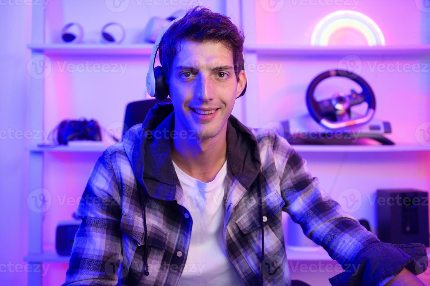 Young Caucasian man Pro Gamer have live streaming  and chatting  with his  fans at home photo