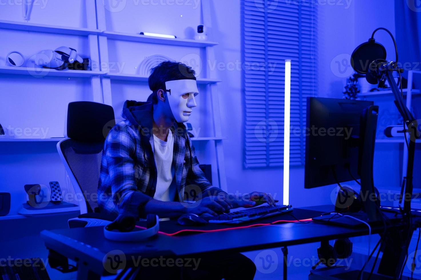 A Hacker is using laptop computer to steal data in the night photo