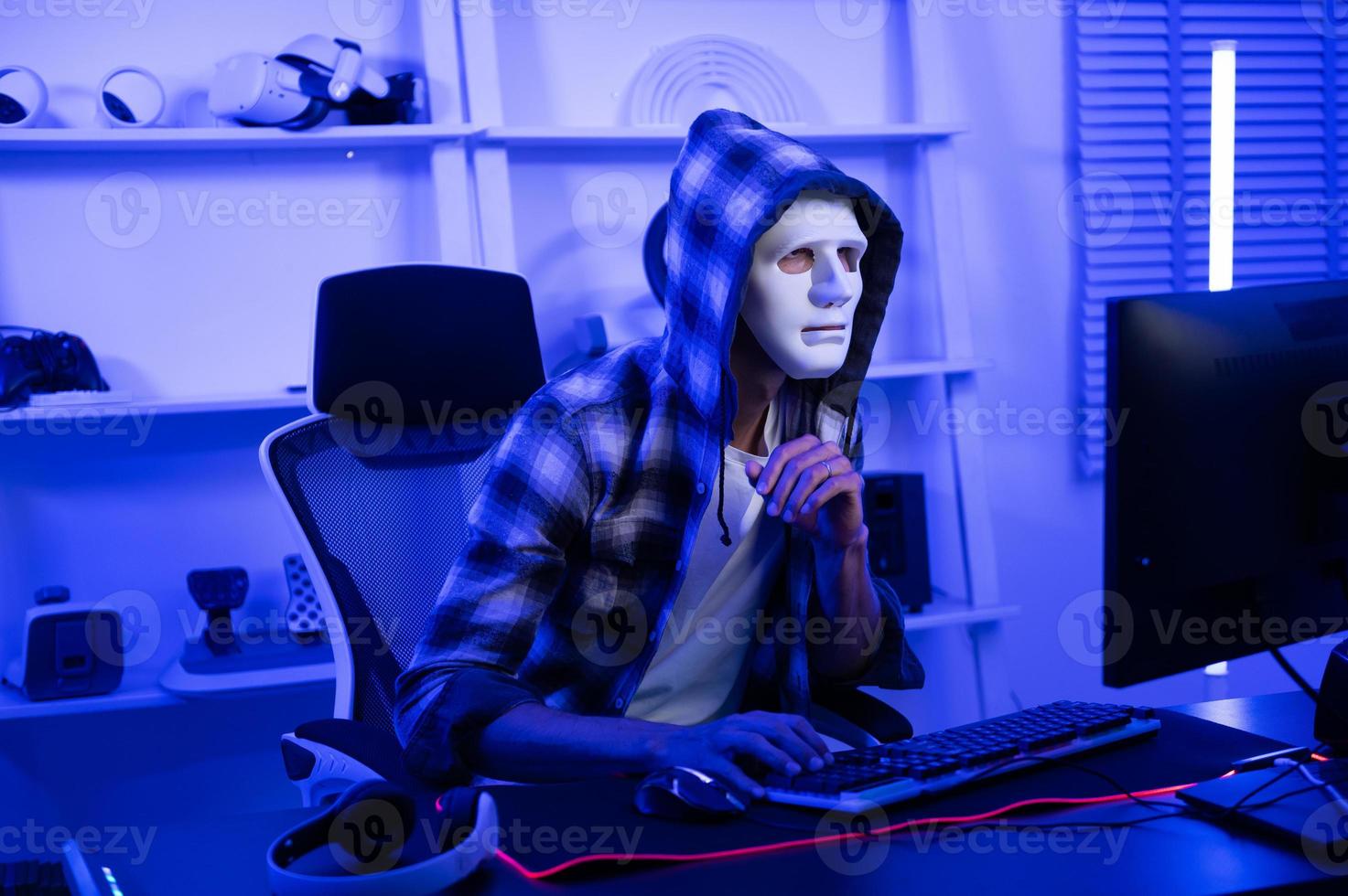 A Hacker is using laptop computer to steal data in the night photo