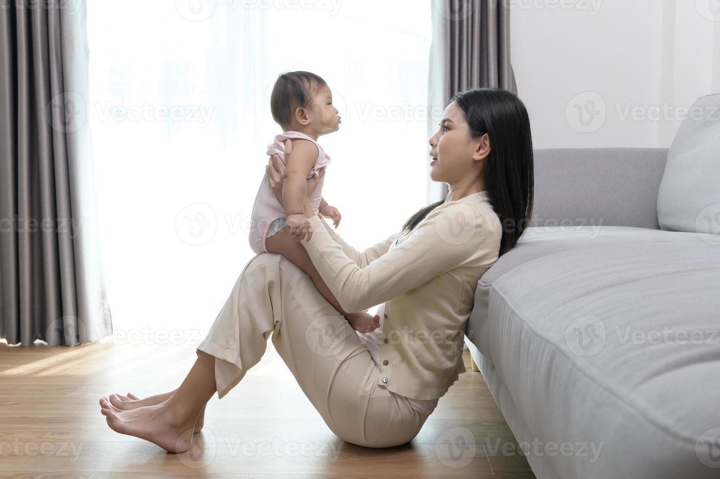 Portrait of mother and baby girl at home, family, child, childhood and parenthood concept photo