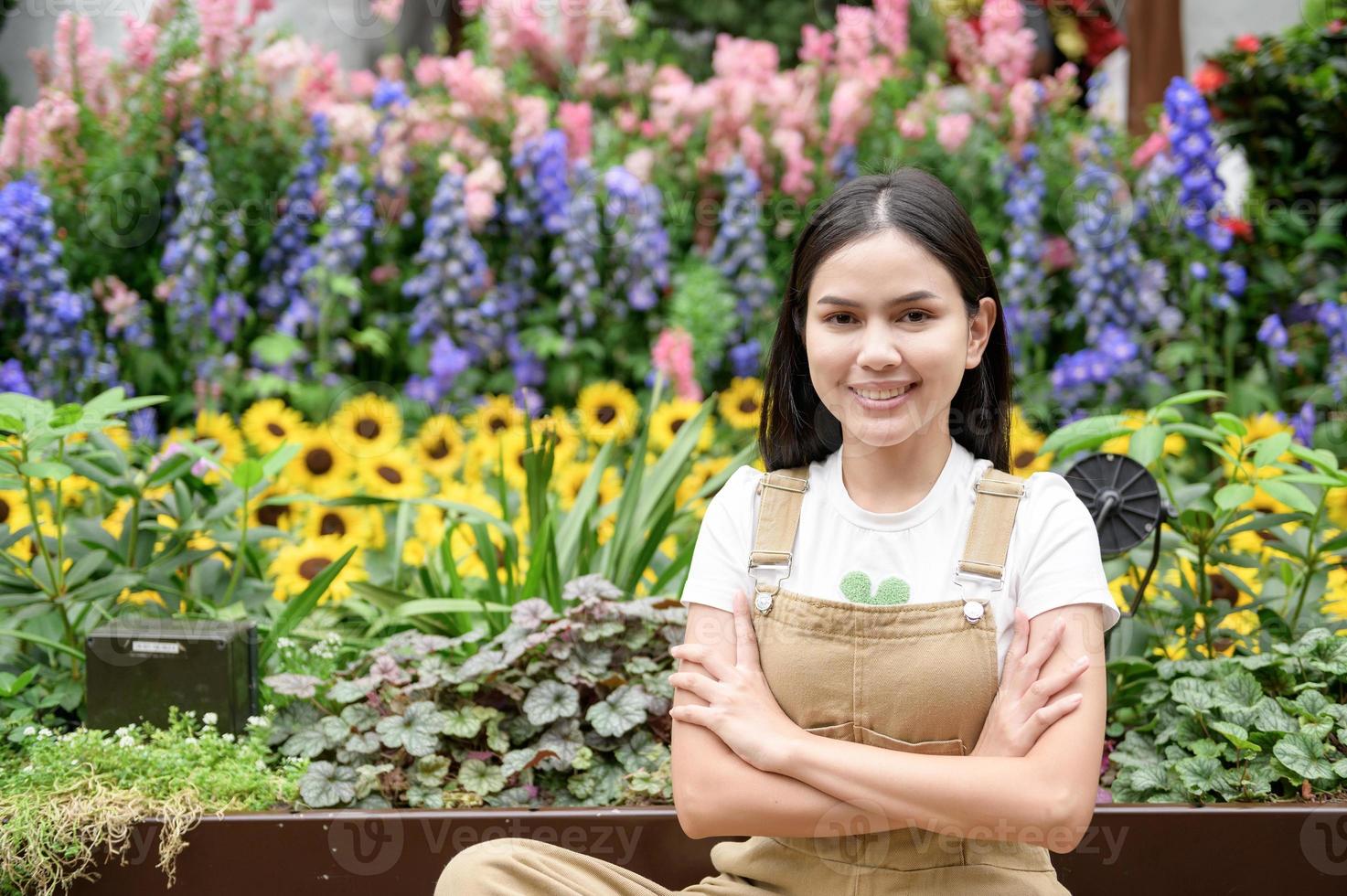 A young woman is smiling in her flower shop , small business concept. photo