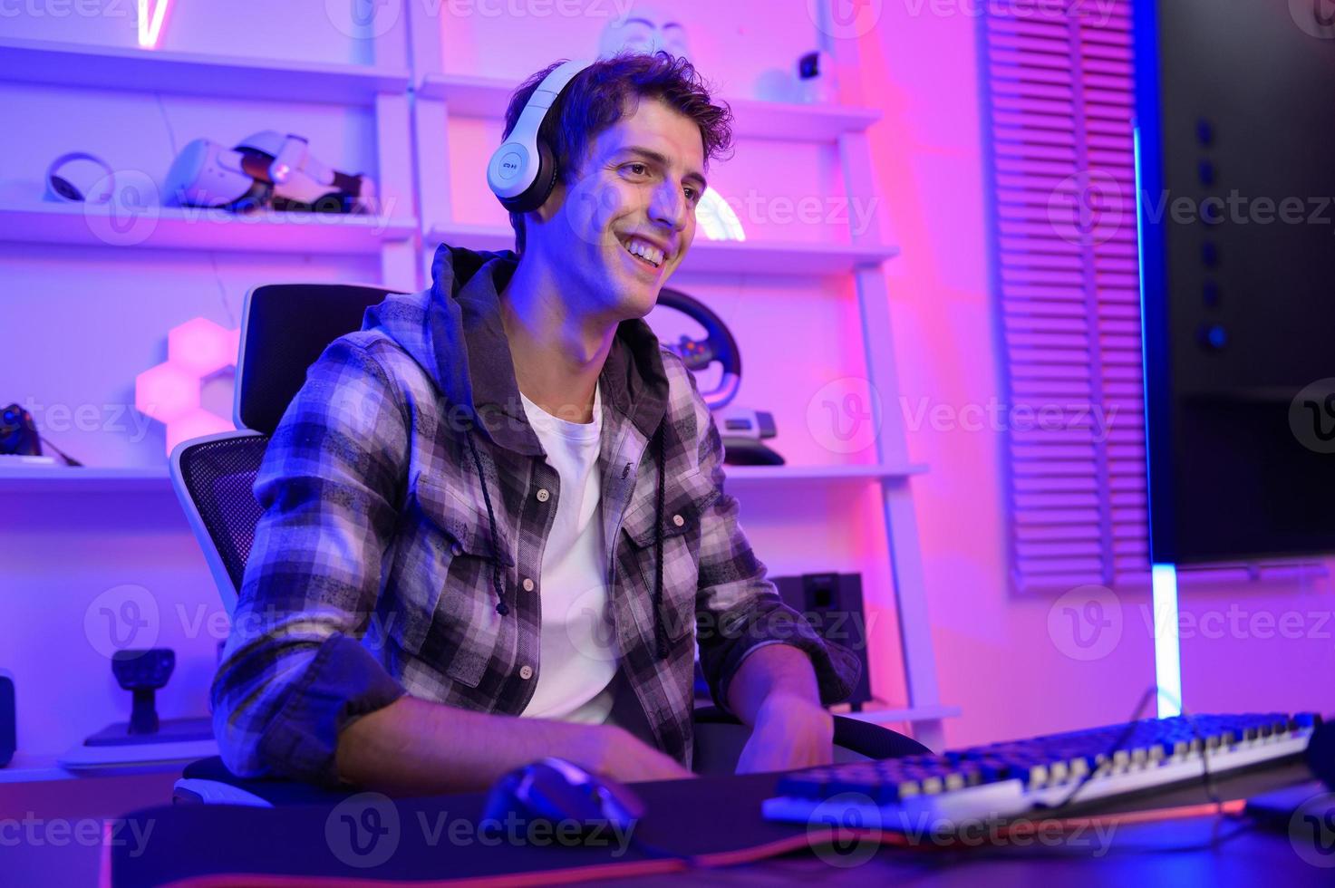 Young Caucasian man Pro Gamer have live streaming  and chatting  with his  fans at home photo