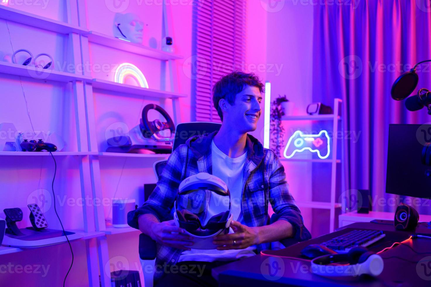 Young Caucasian man Pro Gamer have live streaming  playing video game,  using virtual reality glasses at home photo