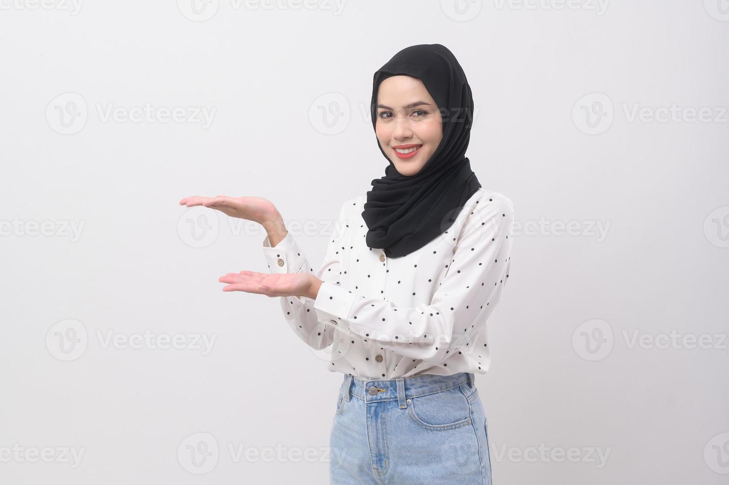Portrait of beautiful muslim woman with hijab over white background studio. photo