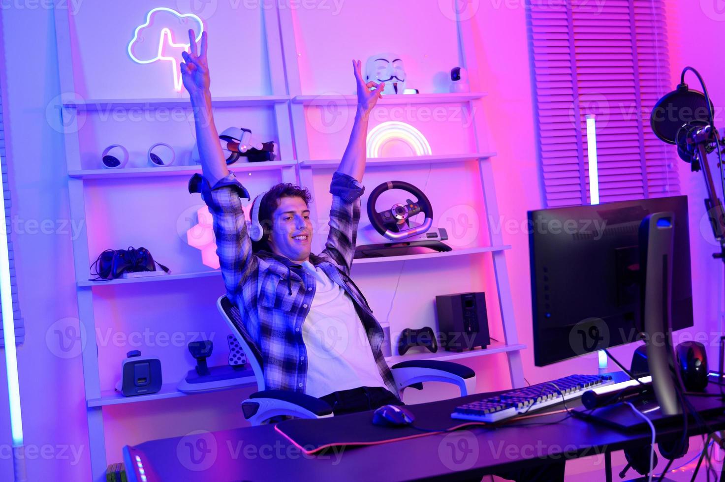 Young Caucasian man Pro Gamer have live streaming  and chatting  with his  fans at home photo