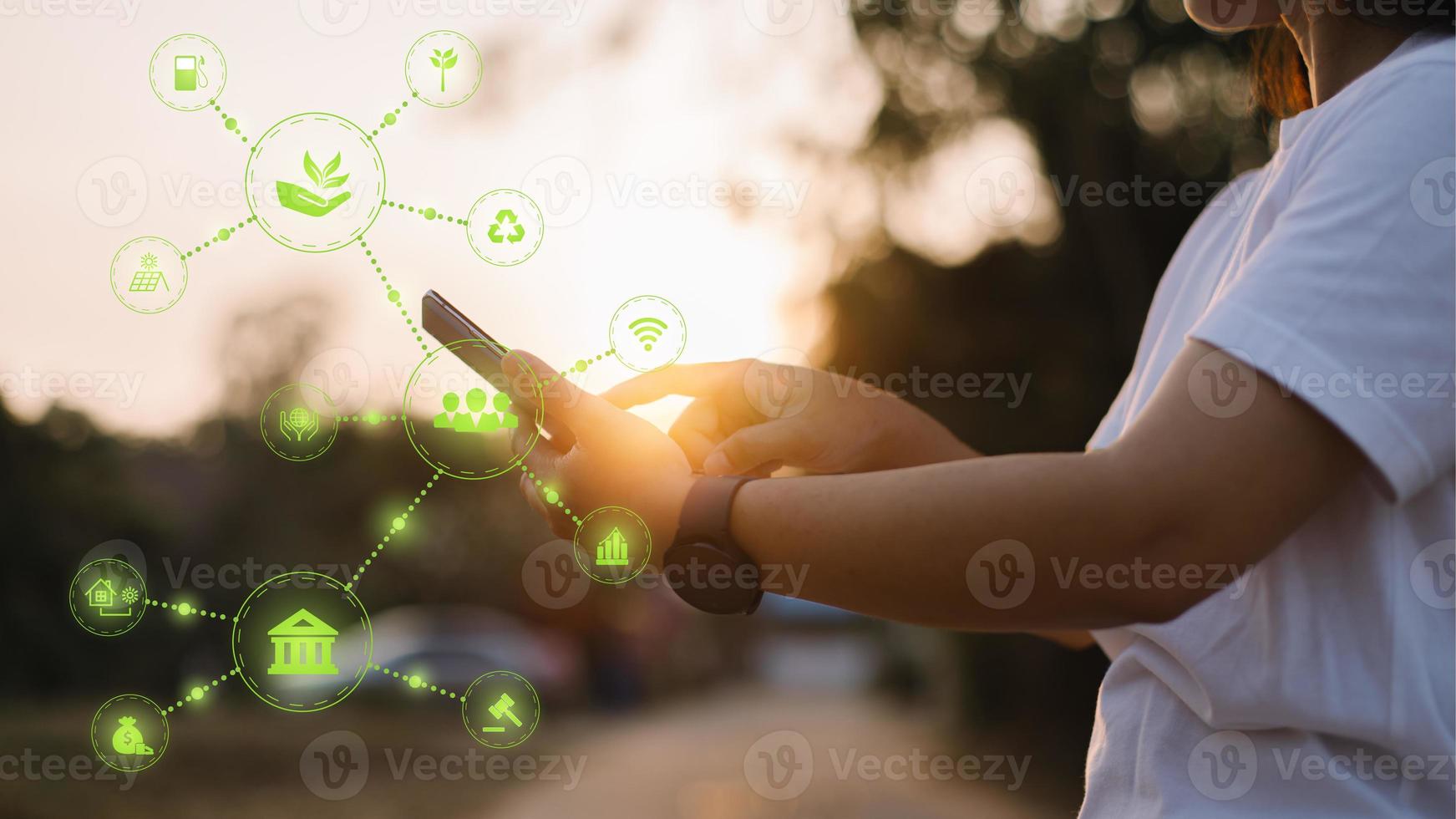 Hand holding Phone ESG icon concept in the hand for environmental, social, and governance in sustainable and ethical business on the Network connection on a green background. photo