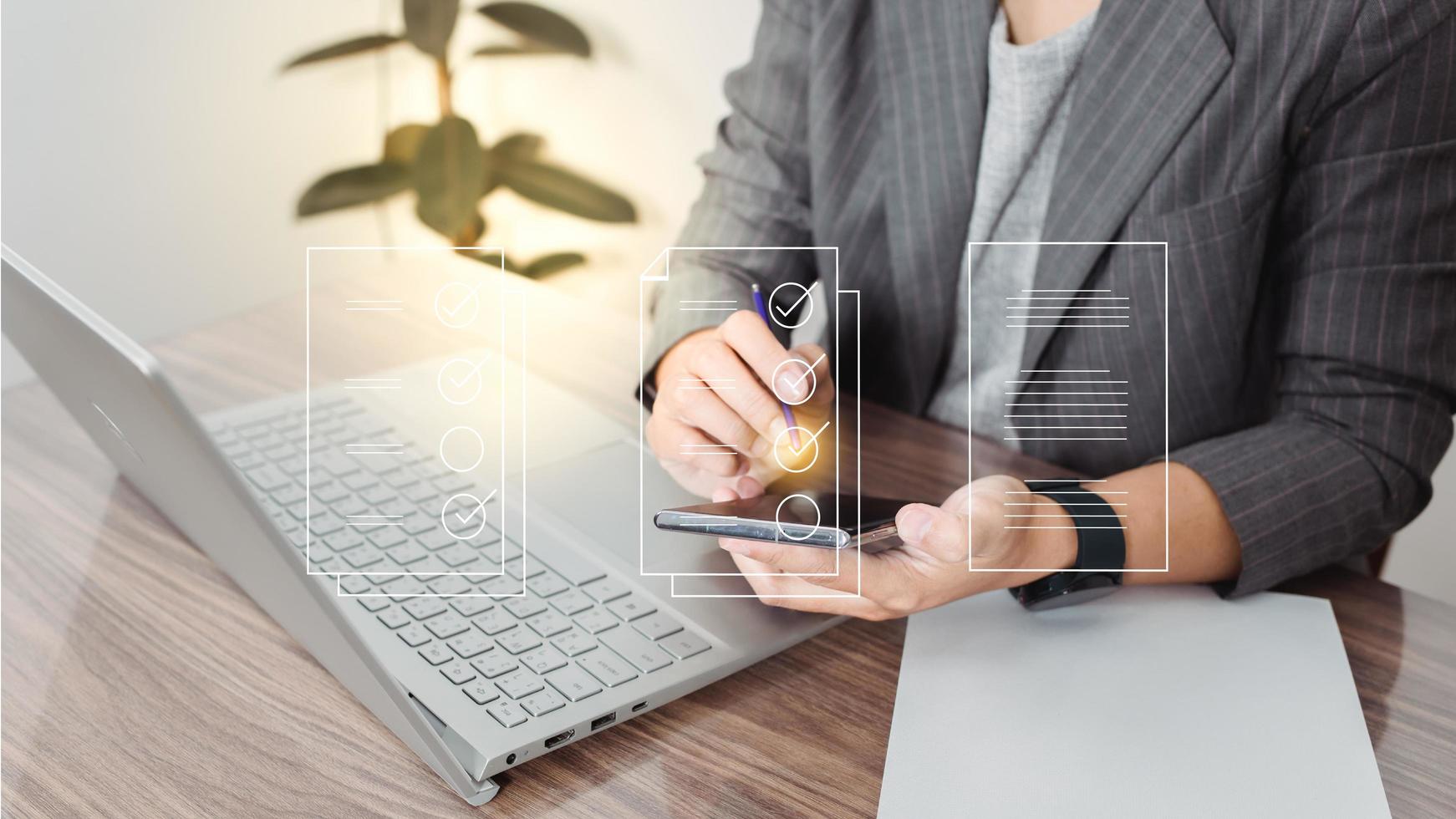 Businesswoman using a laptop and touching on virtual screen contact questionnaire with checkboxes, filling survey form online, answering questions of the test photo