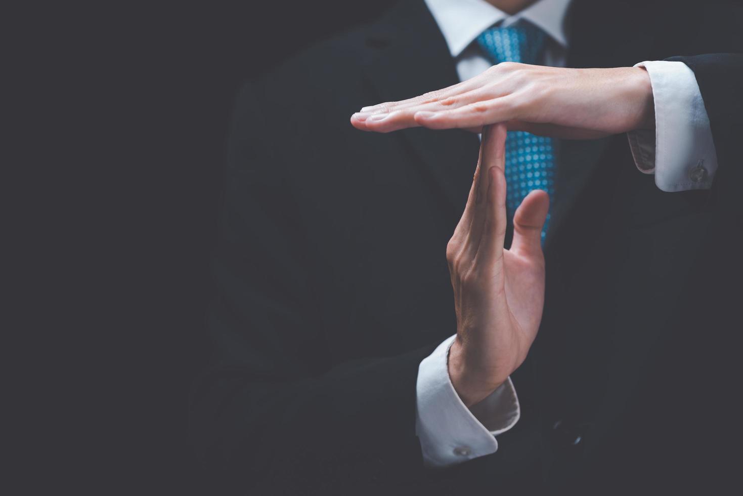 Businessman showing hand sign ,pause or request a break ,time out gesture sign ,time for a break ,Gestures asking for time to consult or clarify photo