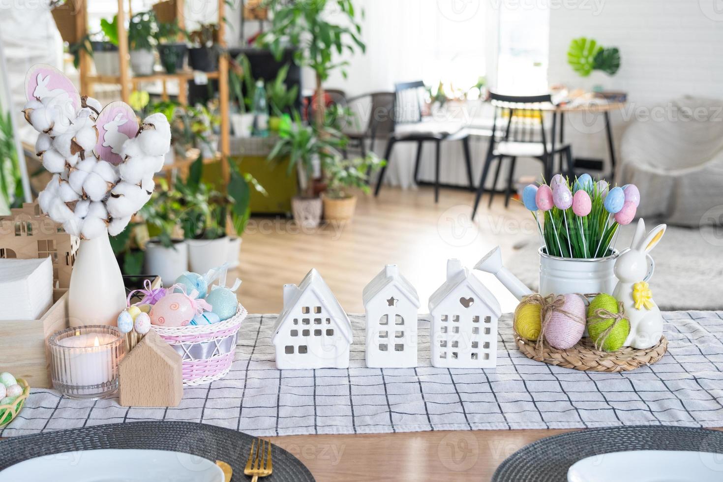 Key to house of cozy home with Easter decor with rabbit and eggs on table of kitchen. Building, design, project, moving to new house, mortgage, insurance, rent and purchase real estate photo