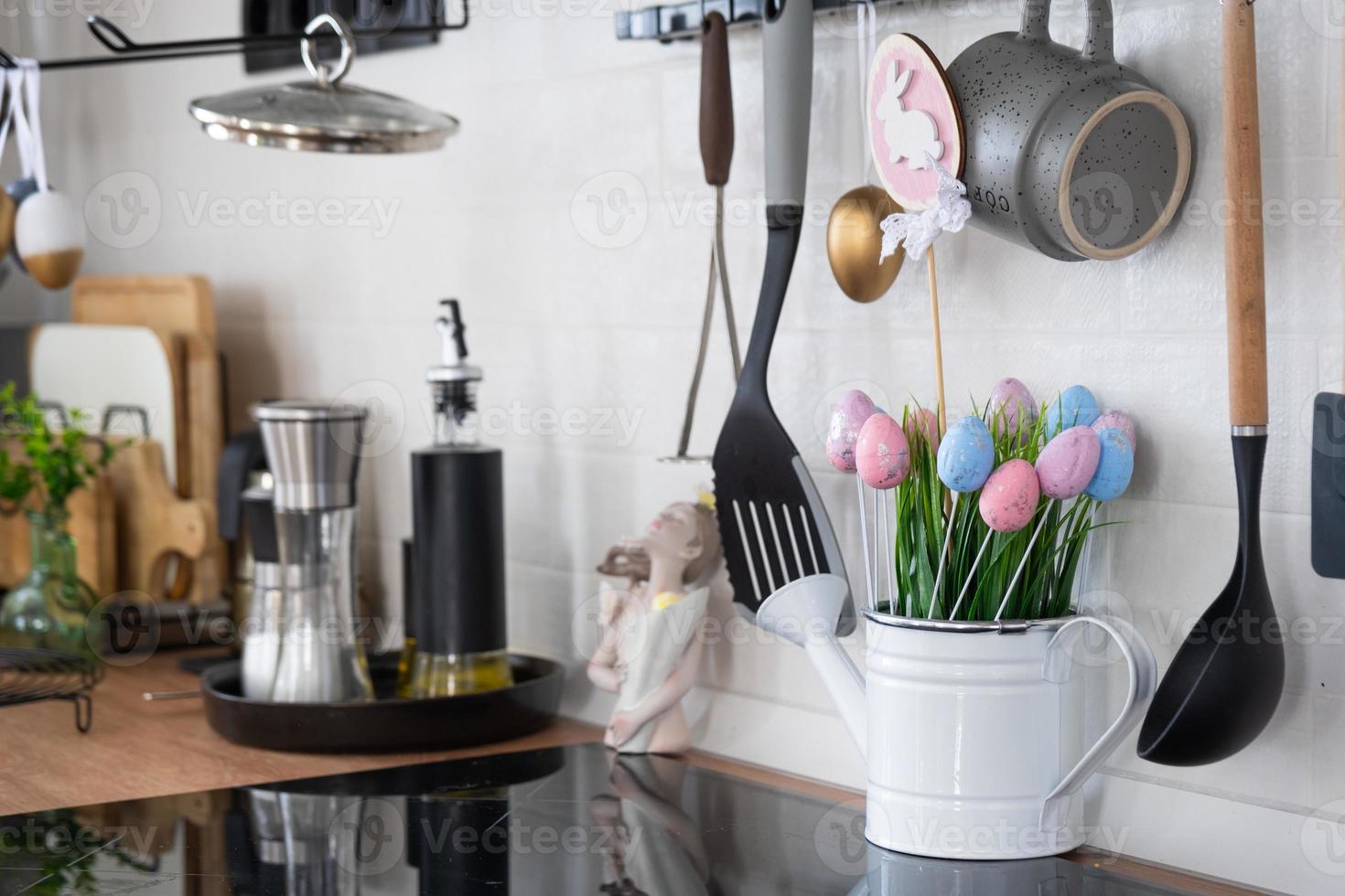 Interior of kitchen and details of decor of utensils with Easter decoration of colorful eggs in a loft style. Festive interior of a country house photo