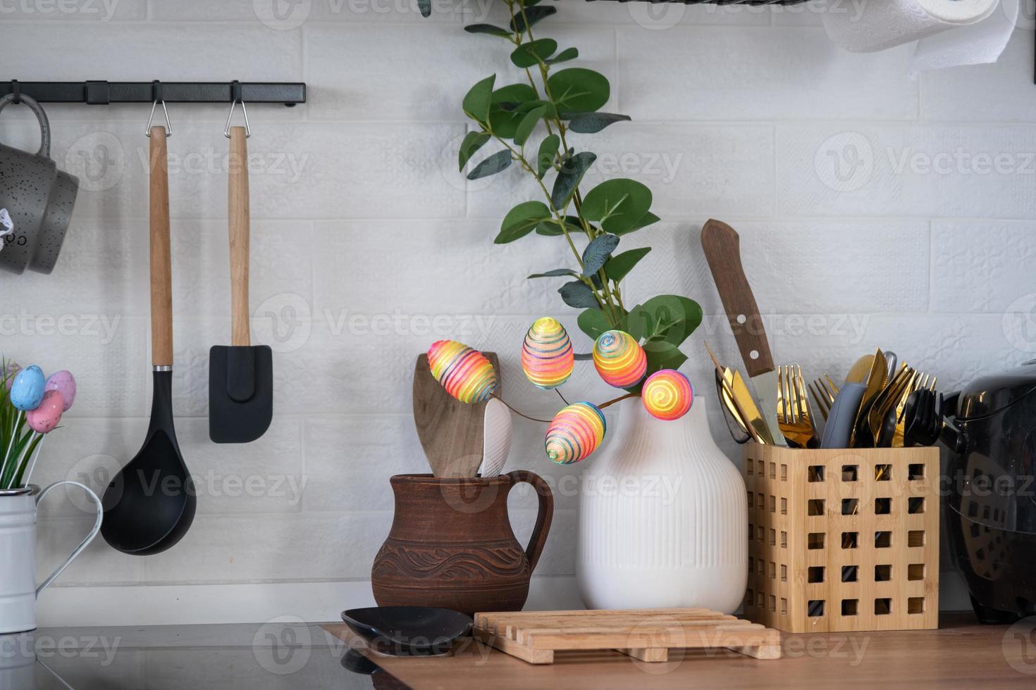 Interior of kitchen and details of decor of utensils with Easter decoration of colorful eggs in a loft style. Festive interior of a country house photo