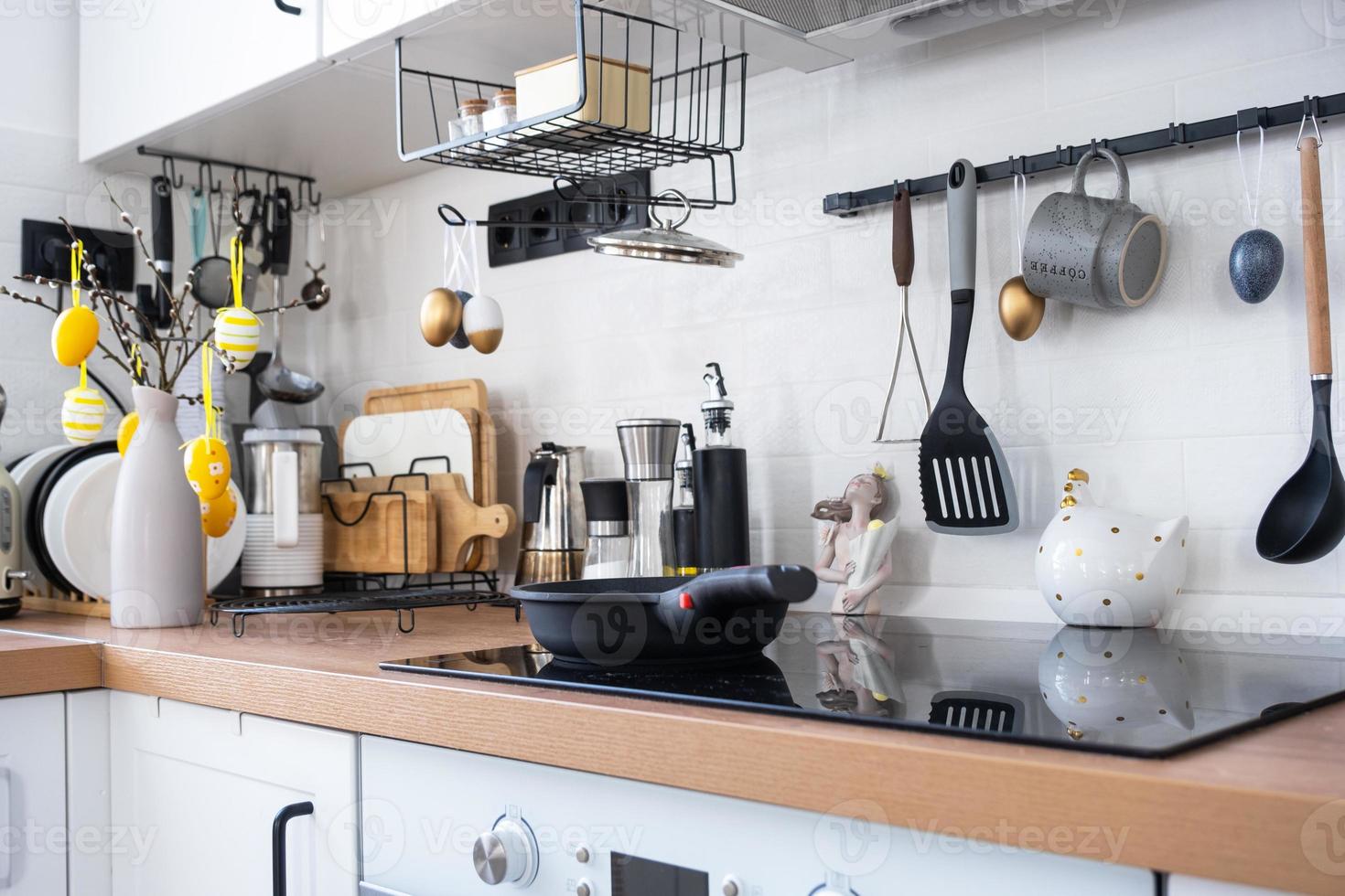 Interior of kitchen and details of decor of utensils with Easter decoration of colorful eggs in a loft style. Festive interior of a country house photo