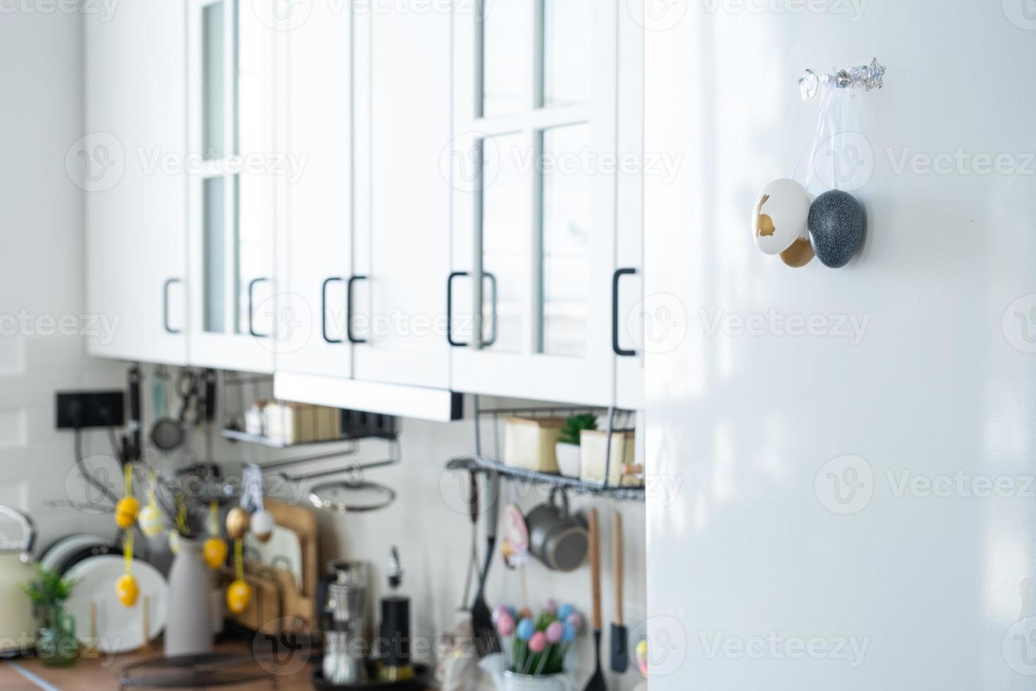 Interior of kitchen and details of decor of utensils with Easter decoration of colorful eggs in a loft style. Festive interior of a country house photo