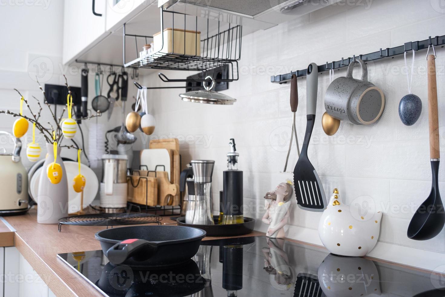 Interior of kitchen and details of decor of utensils with Easter decoration of colorful eggs in a loft style. Festive interior of a country house photo