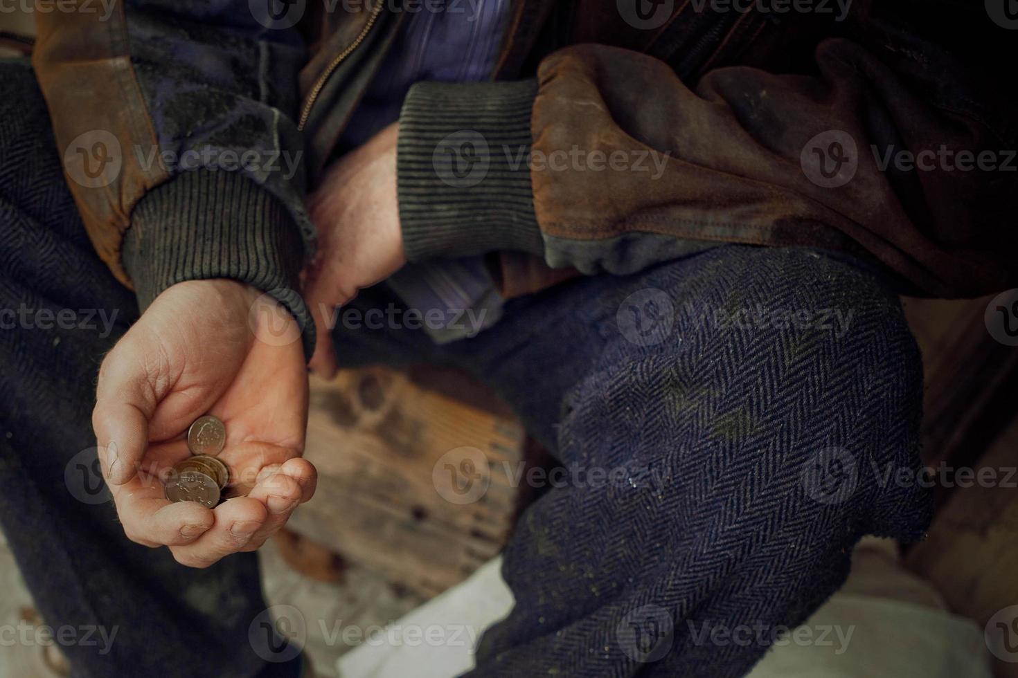 The hand of an elderly man holding Ukrainian money. Poverty, donations, unemployment. photo