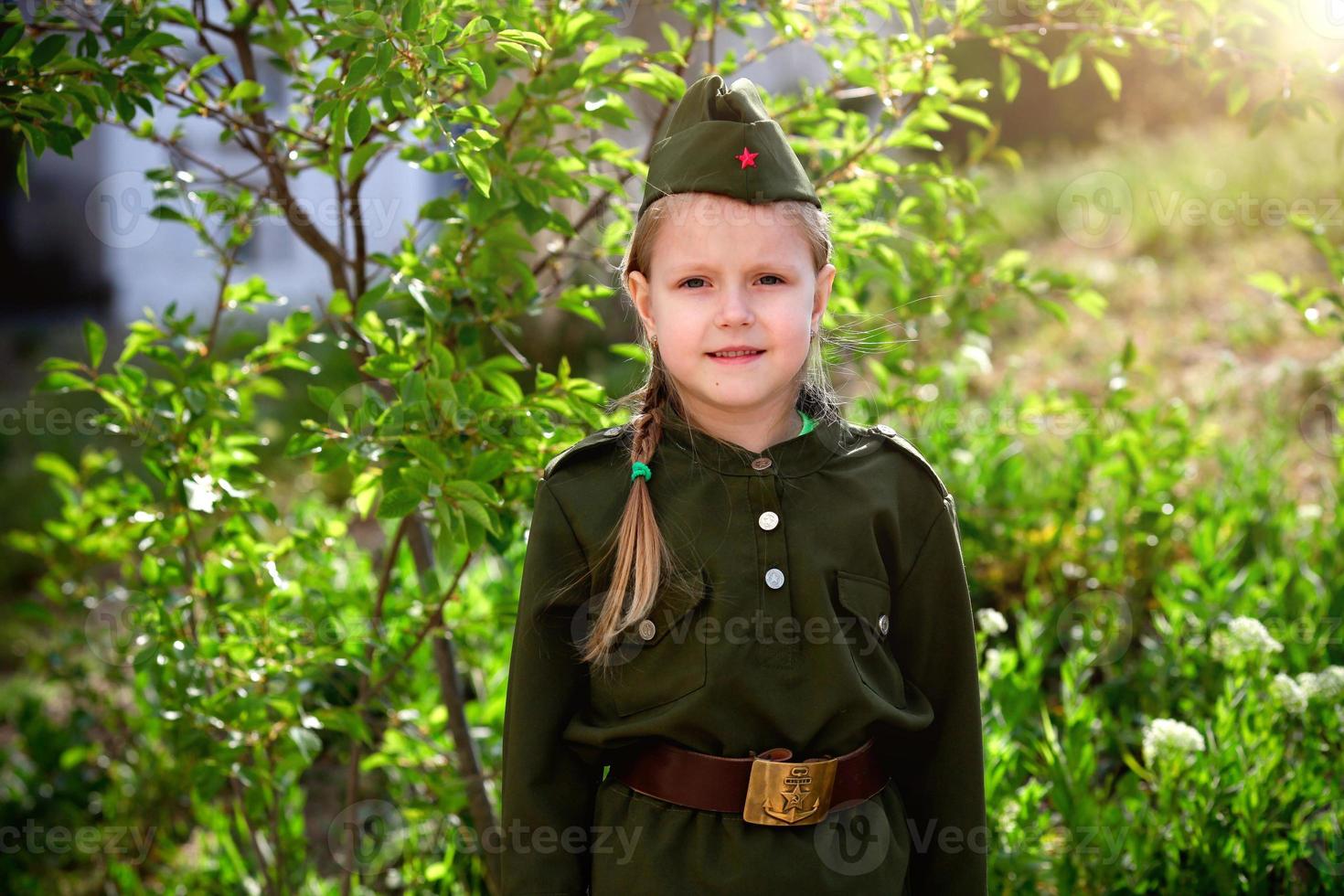 Portrait of a girl in uniform on a green background. Victory Day . photo