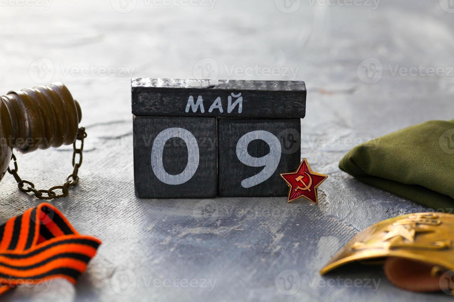 Flask, Gergiev ribbon, cap, army belt with the image of a sickle ,  hammer and wooden calendar with the date May 09. photo