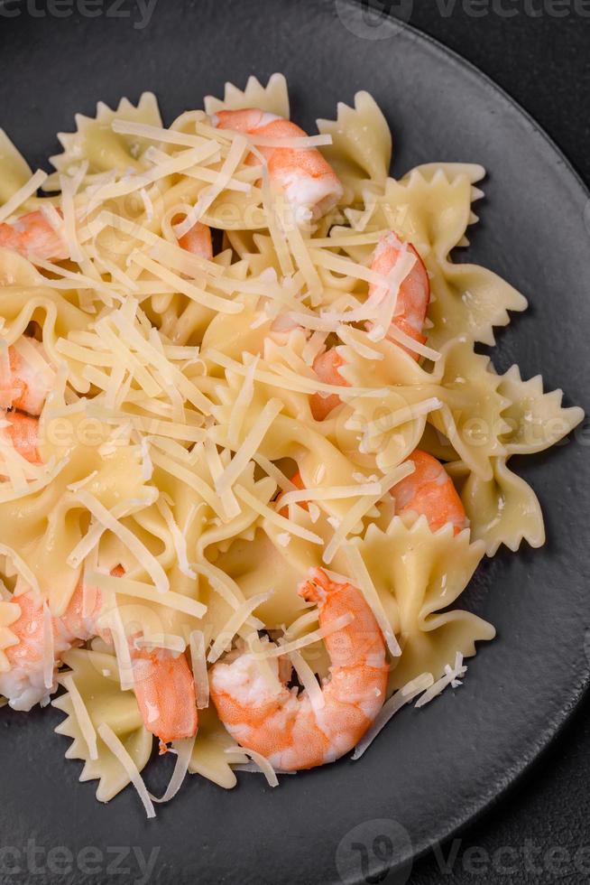 Delicious farfalle pasta with langoustine shrimp with creamy sauce photo