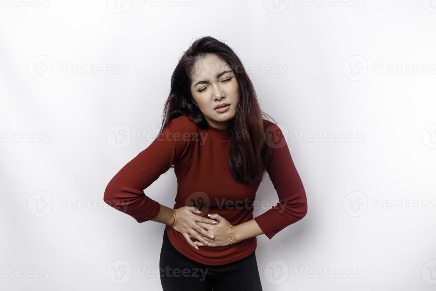 Photo of young unwell sick ill woman hold hand on stomach suffers pain isolated on white background