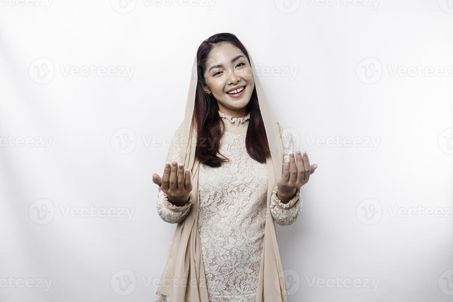 Religious beautiful Asian Muslim girl wearing a headscarf praying to God. photo
