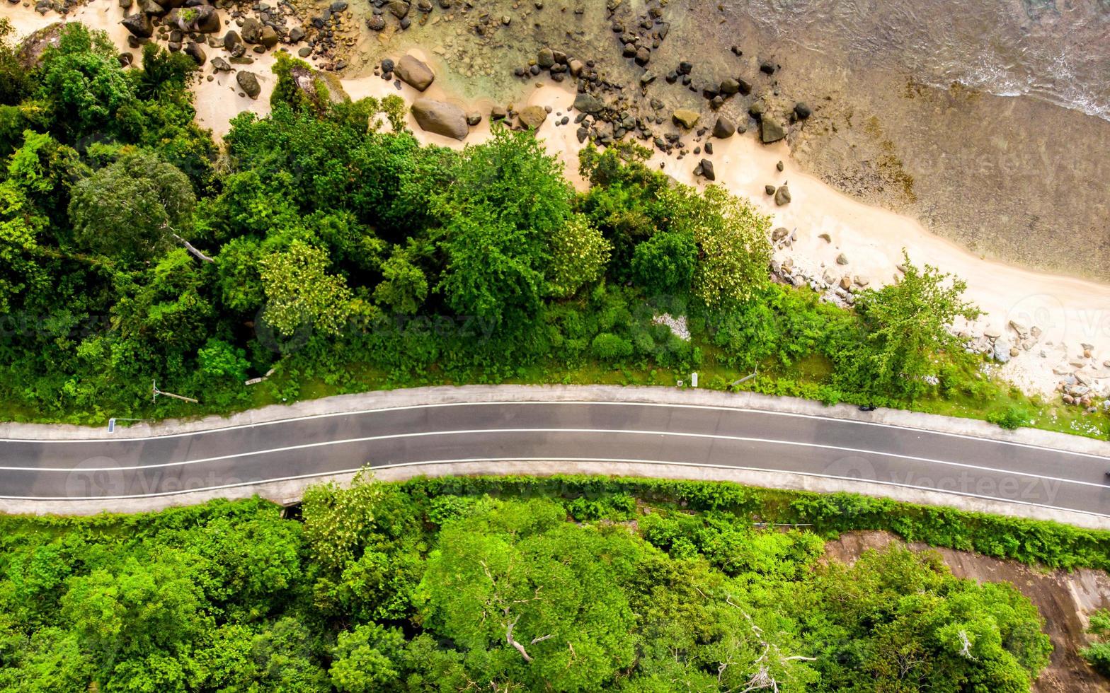 Aerial view of empty road with green forest photo