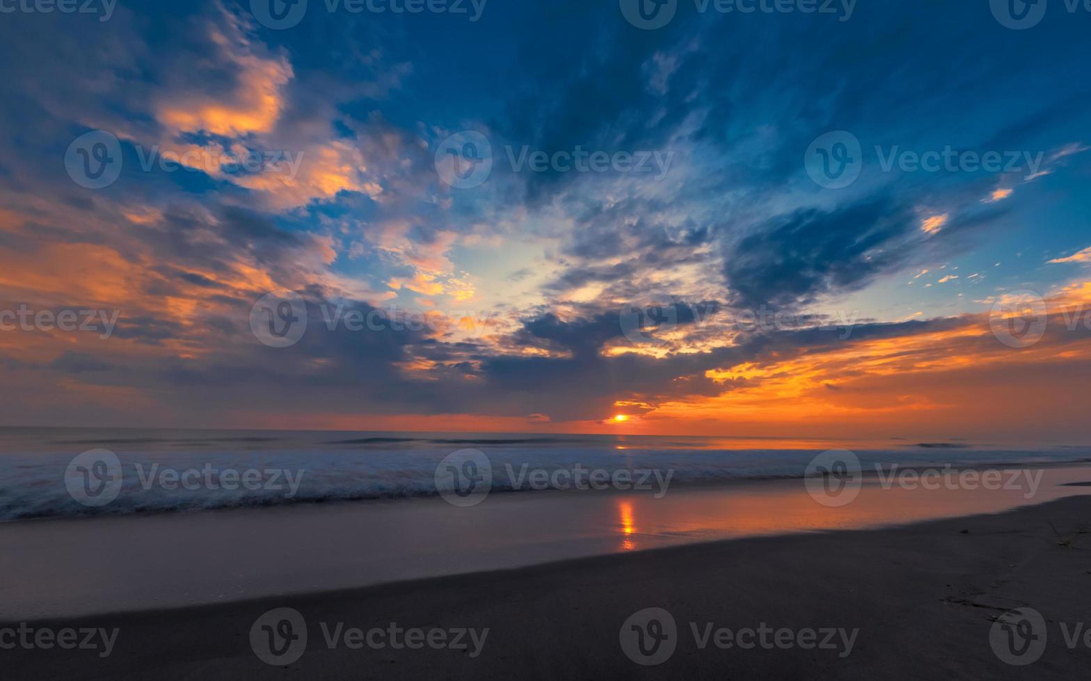 Beautiful tropical seascape, sunset at beach with colorful sky photo