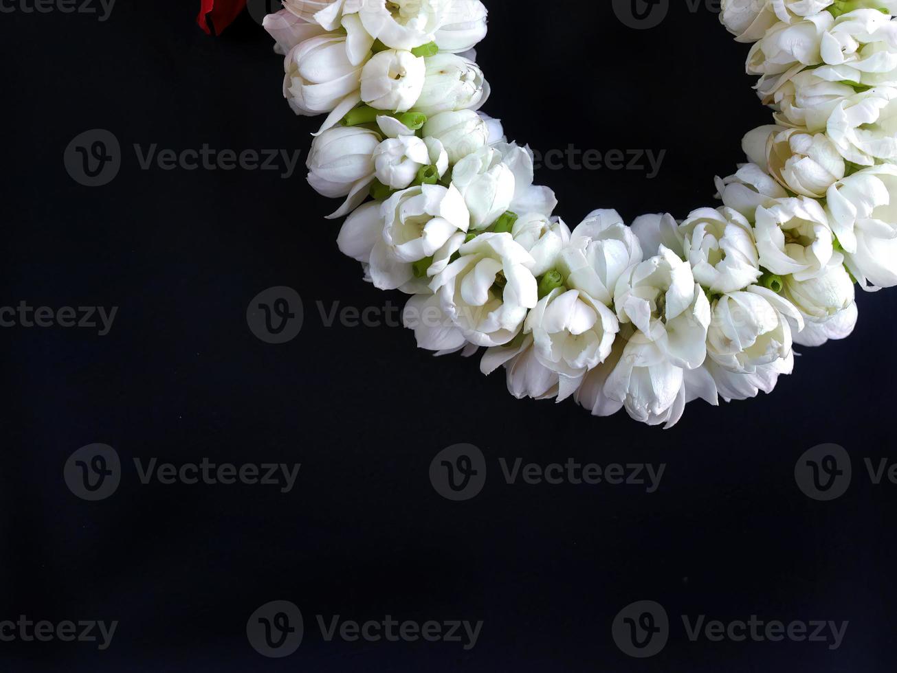 Close up part of Thai traditional style, jasmine garland, symbol of mother day, homage to a Buddha Jasmine, Maalai, art design, in dark background with blank copy space photo