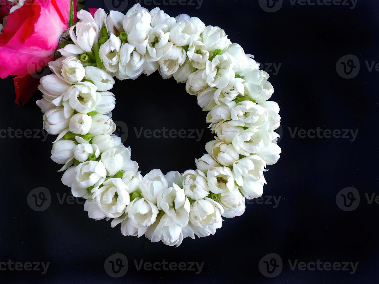 Close up part of Thai traditional style, jasmine garland, symbol of mother day, homage to a Buddha Jasmine, Maalai, art design, in dark background with blank copy space photo