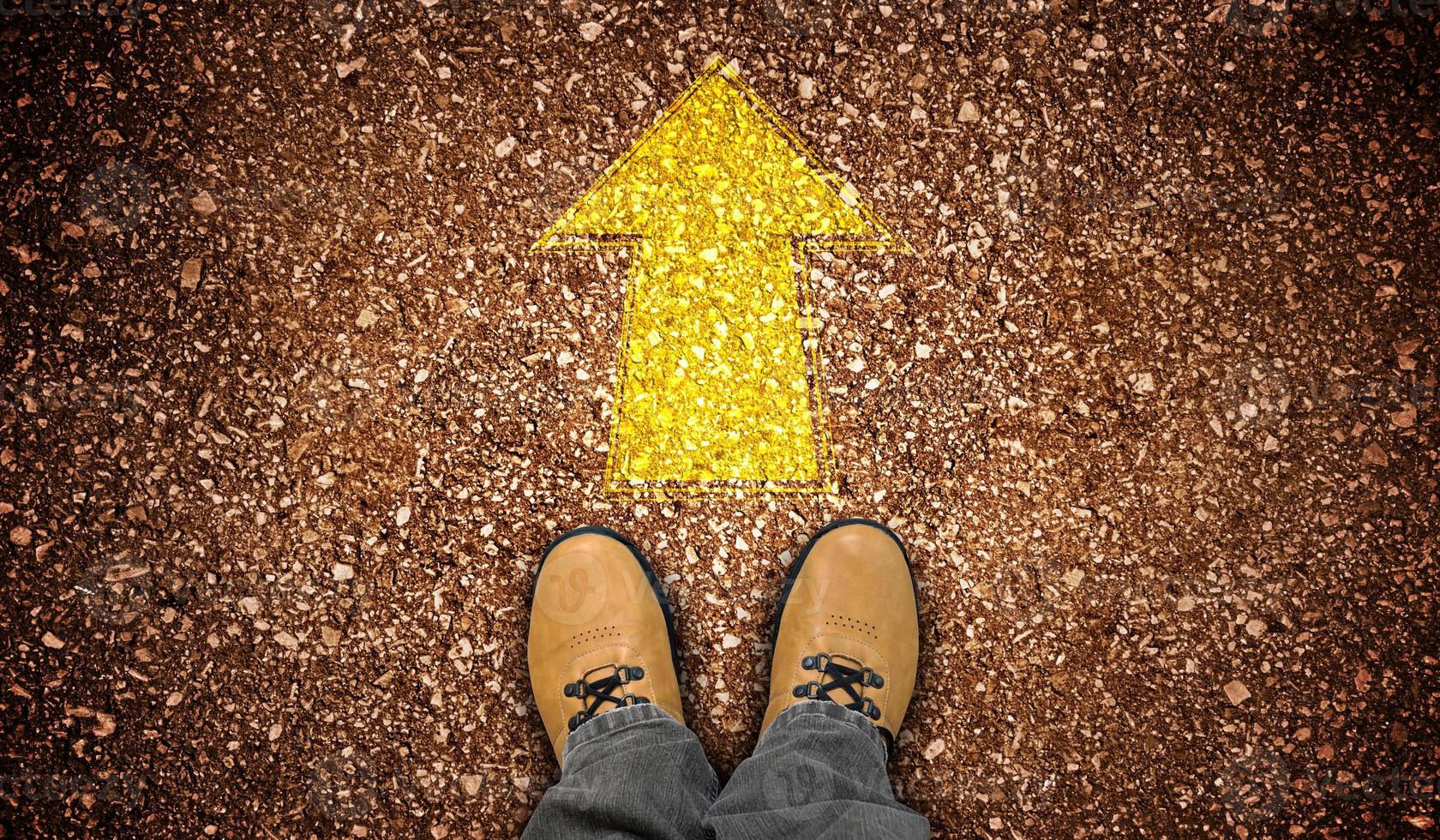 Yellow Leather Shoes and Chalky Arrow on Ground - Forward Concept photo