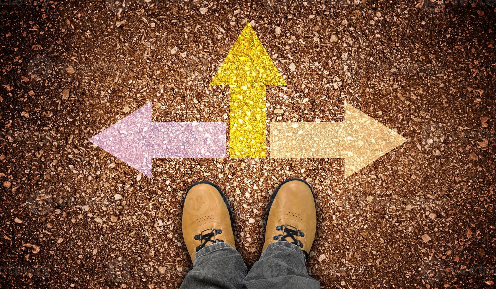 Yellow Leather Shoes and Three Colorful Chalky Arrows on Ground - Strategy Concept photo