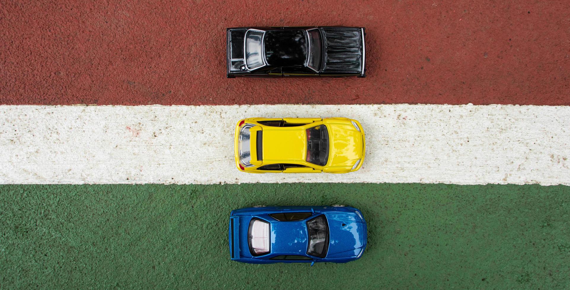 3 toy cars placed at the edge of the court line, after some edits. Concept for ready to race. photo