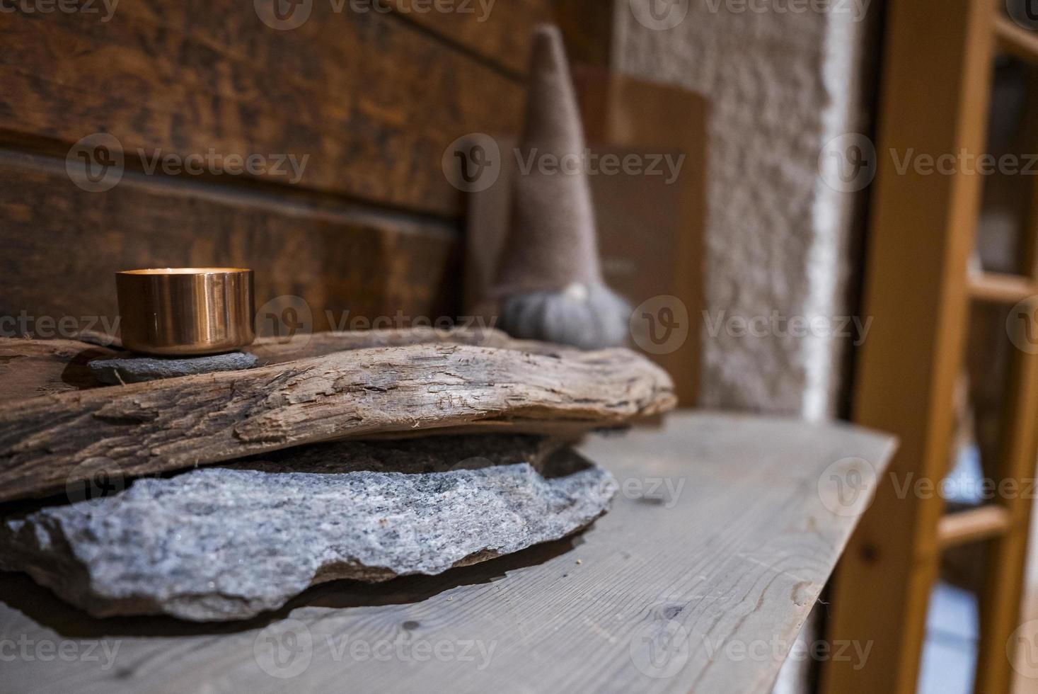 Illuminated container on stack of rustic wood in hotel photo