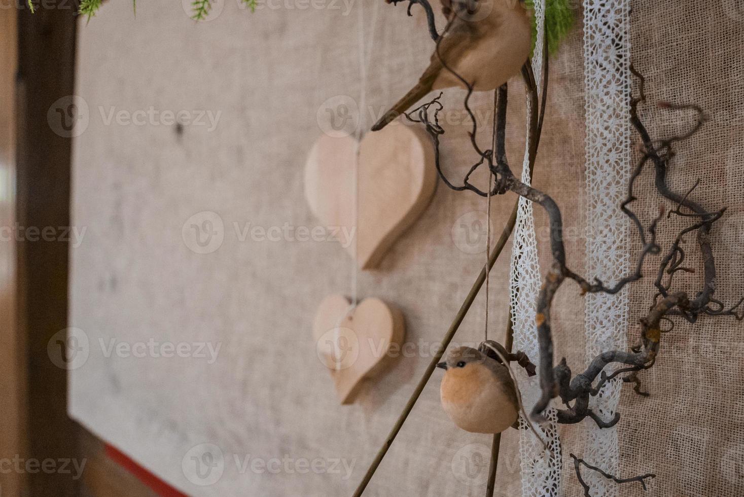 Bird decoration and ribbon hanging in front of burlap at hotel photo