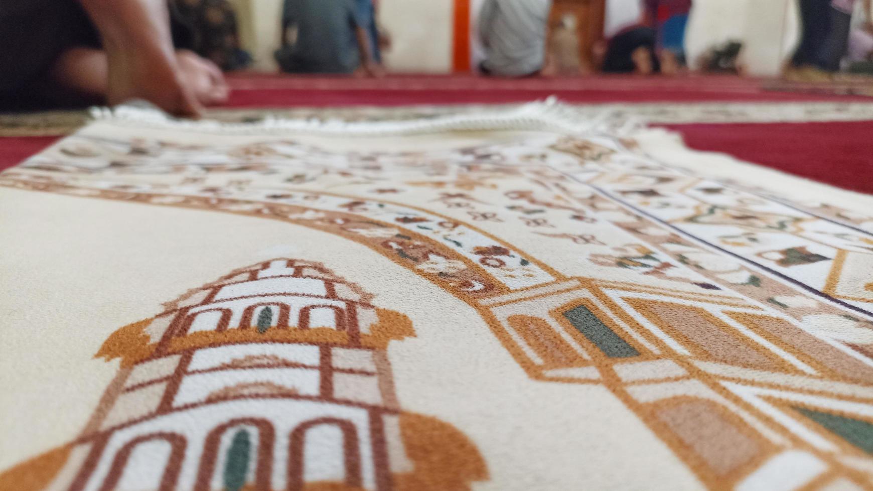 Indonesia - Jakarta, March 17 2023, The atmosphere of people praying on prayer mats and a pulpit in the mosque can be seen. photo