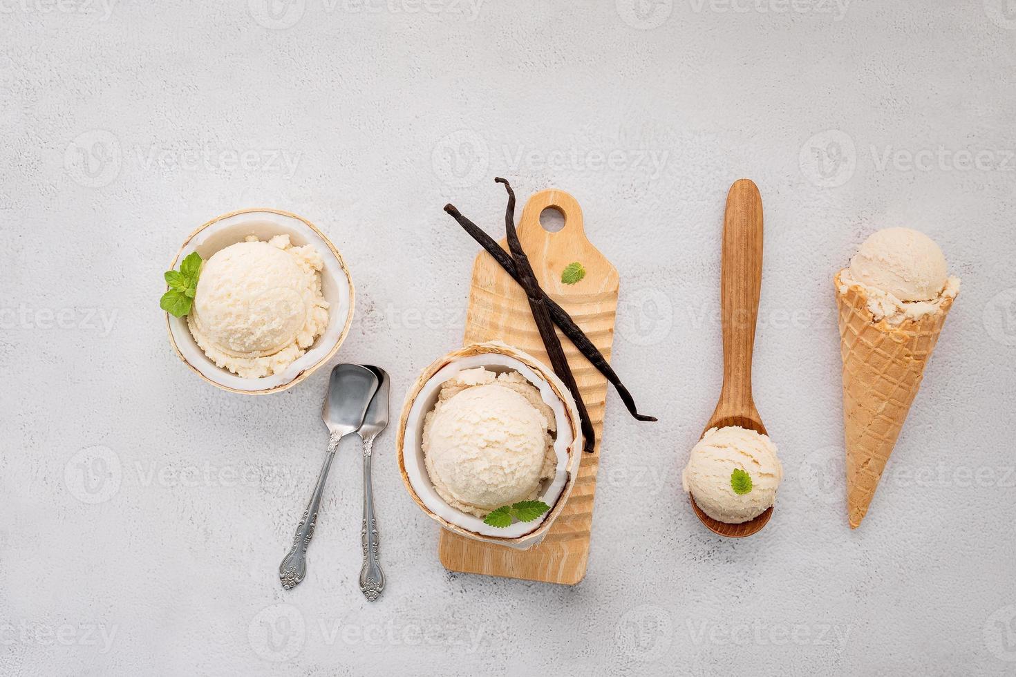 Coconut ice cream flavours in half of coconut setup on white stone background. Summer and Sweet menu concept. photo