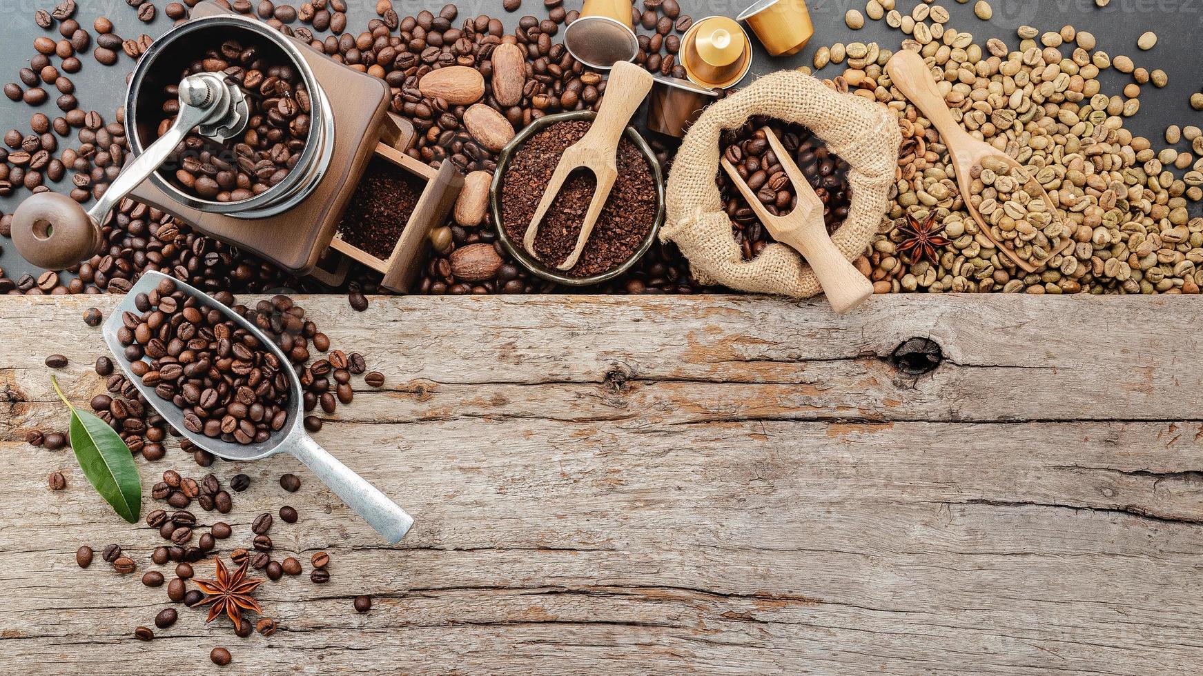 Background of various coffee , dark roasted coffee beans , ground and capsules with scoops setup on wooden background with copy space. photo