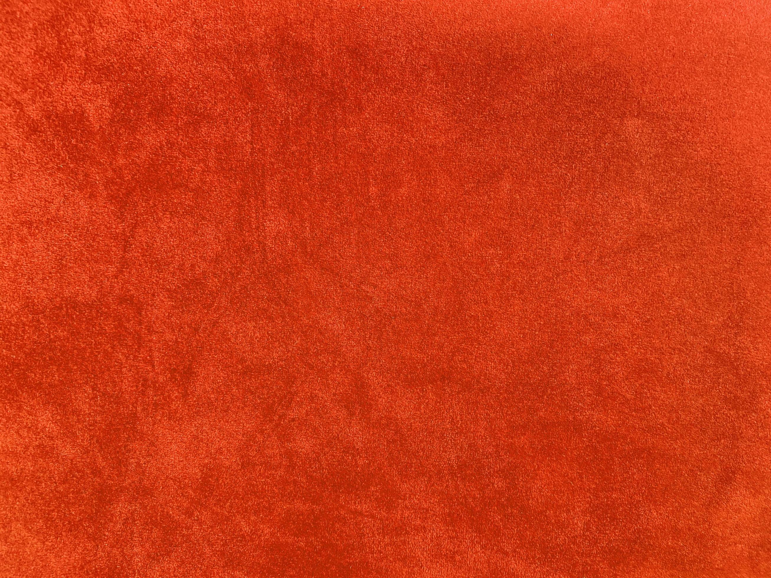 Orange velvet fabric texture used as background. Empty Orange fabric