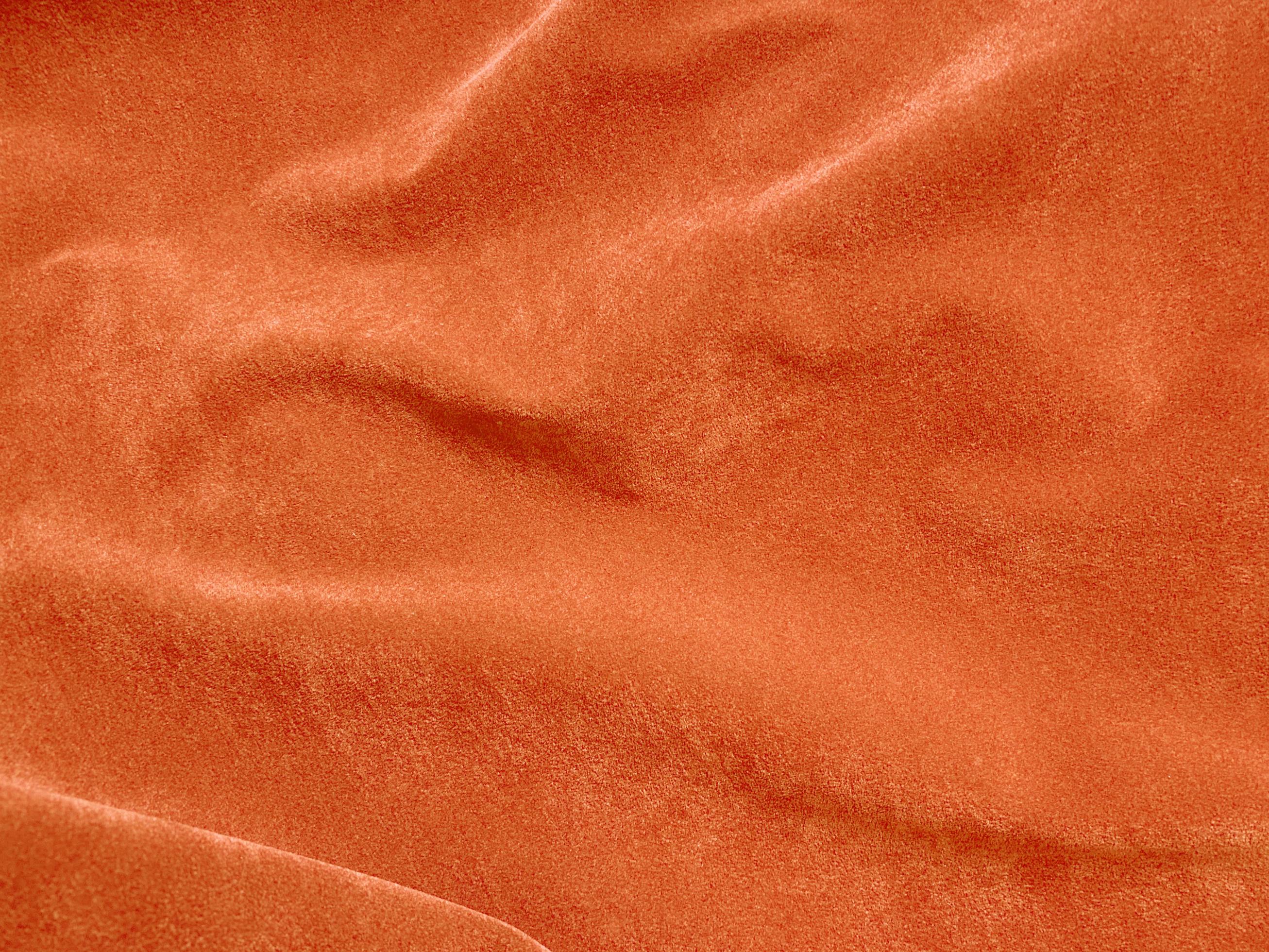 Orange velvet fabric texture used as background. Empty Orange fabric
