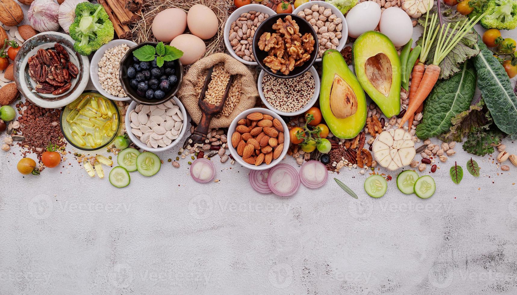 Ingredients for the healthy foods selection. The concept of superfoods set up on white shabby concrete background with copy space. photo