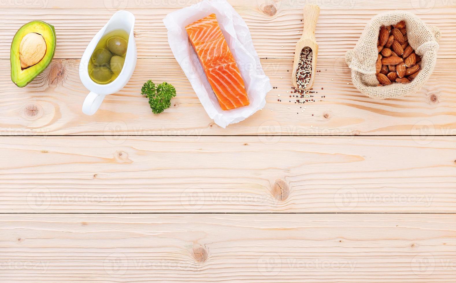 Ketogenic low carbs diet concept. Ingredients for the healthy foods selection setup on wooden background with copy space. photo