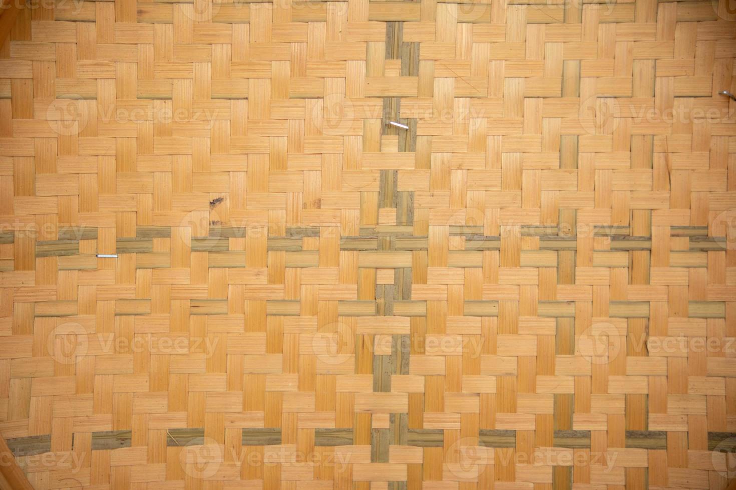 Beautiful patterned background caused by weaving bamboo into a pattern in the desired pattern to decorate the wall beautifully with natural materials. The bamboo background is woven beautifully photo